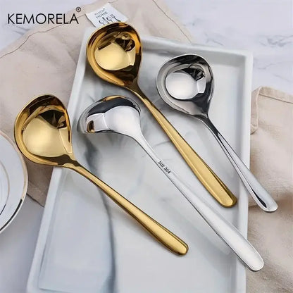 Set of four modern stainless steel small gravy ladles in polished gold and silver finishes with long handles for dining