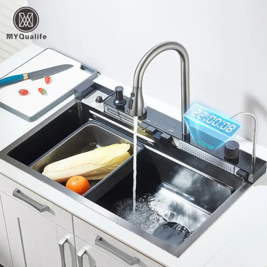 Modern stainless steel waterfall kitchen sink faucet with sleek curved spout and integrated digital display showing temperature and time