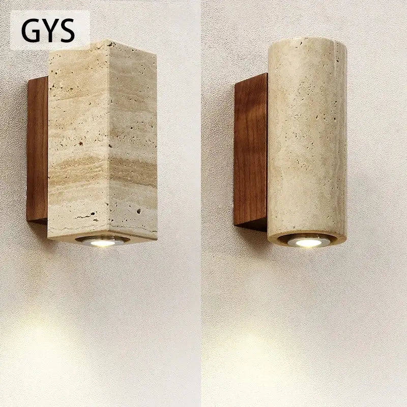 Modern stone and wood wall lamp with rectangular cave stone body and dark wood accent emitting warm light decorbites cave stone