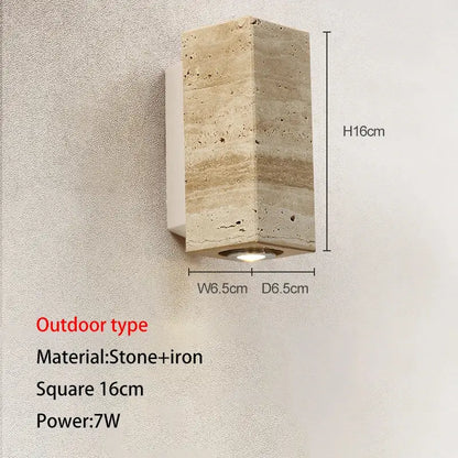 A modern wall lamp in textured beige cave stone and iron with integrated led light for decorbites cave stone outdoor use