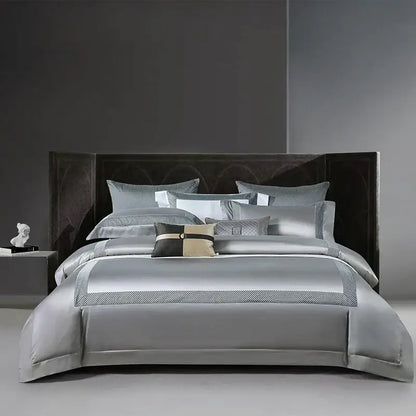 Silver satin bedding set with subtle geometric embroidery and coordinating pillows for decorbites king size luxury bedroom