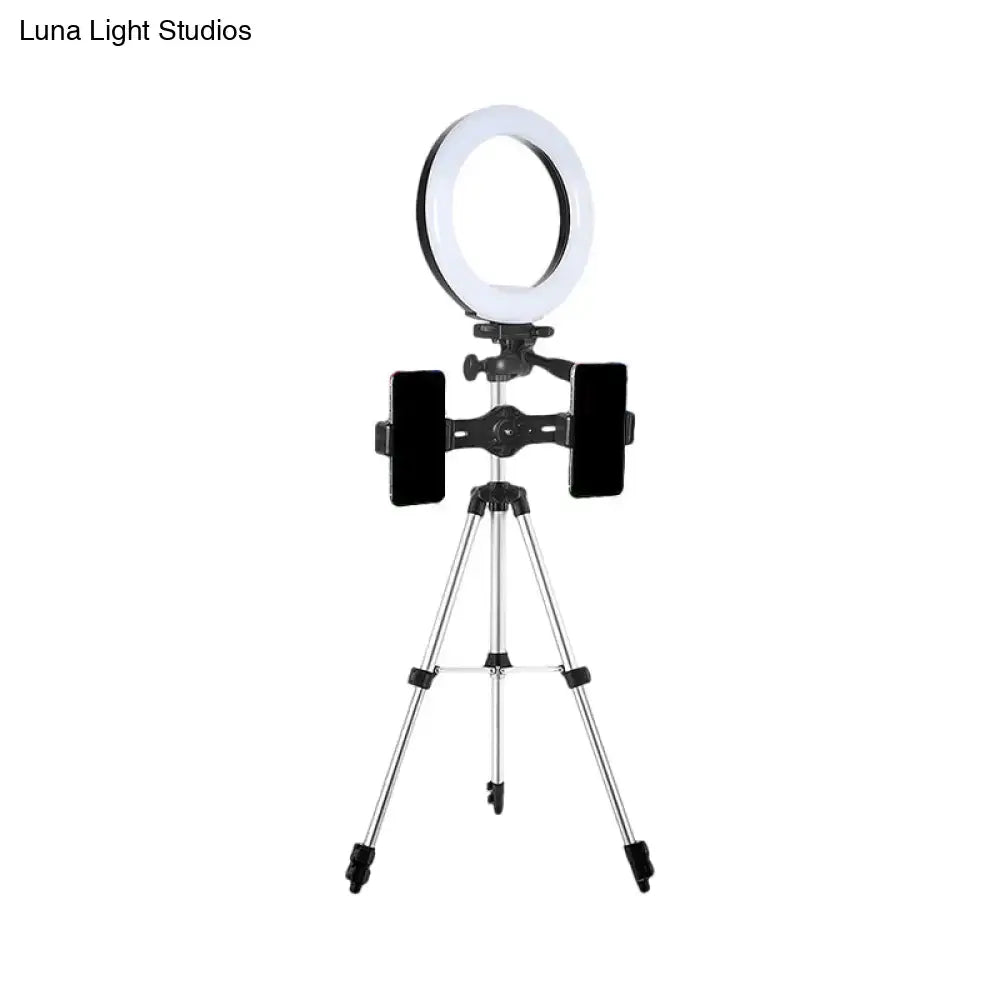 Modern style black and silver led ring flash light with tripod stand and two smartphone holders for office use