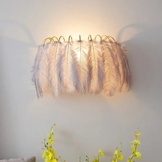 Modern style grey white sconce light with soft white feathers and curved golden frame for parlor wall decor