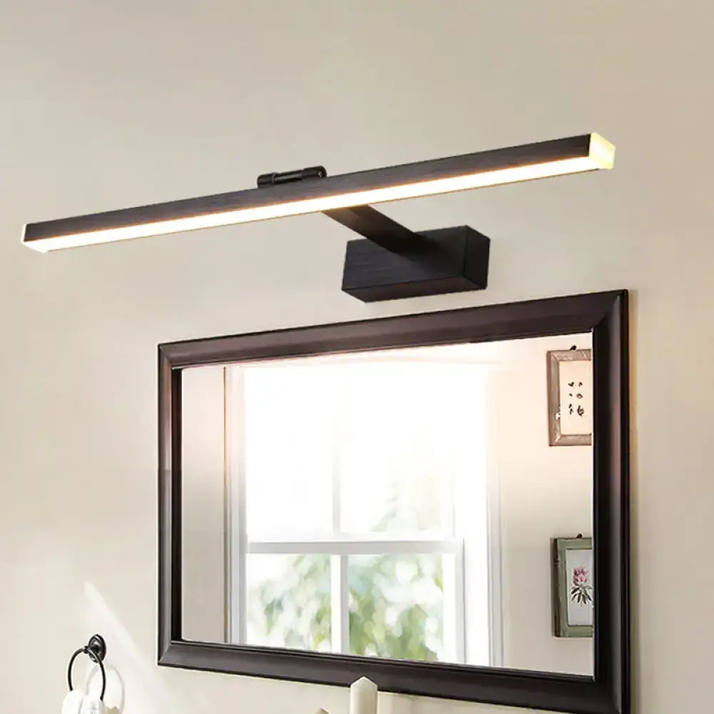 Modern style slender black led vanity light with warm white glow mounted above a bathroom mirror with adjustable shade height