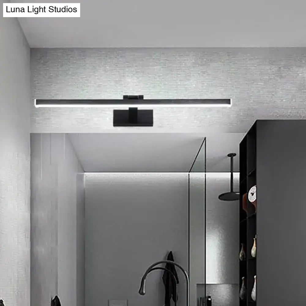 Modern style slender black led vanity light with warm white glow and compact shade height mounted above mirror