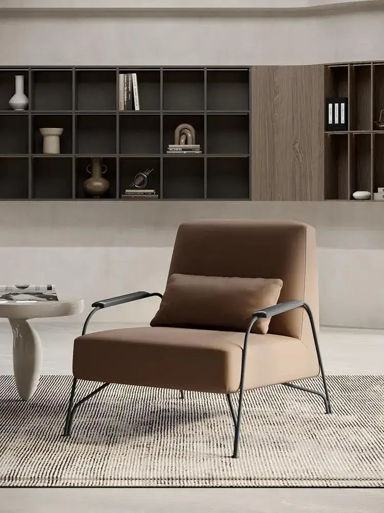 Modern taupe italian style single sofa chair in beige upholstered fabric with sleek black metal frame and matching cushion
