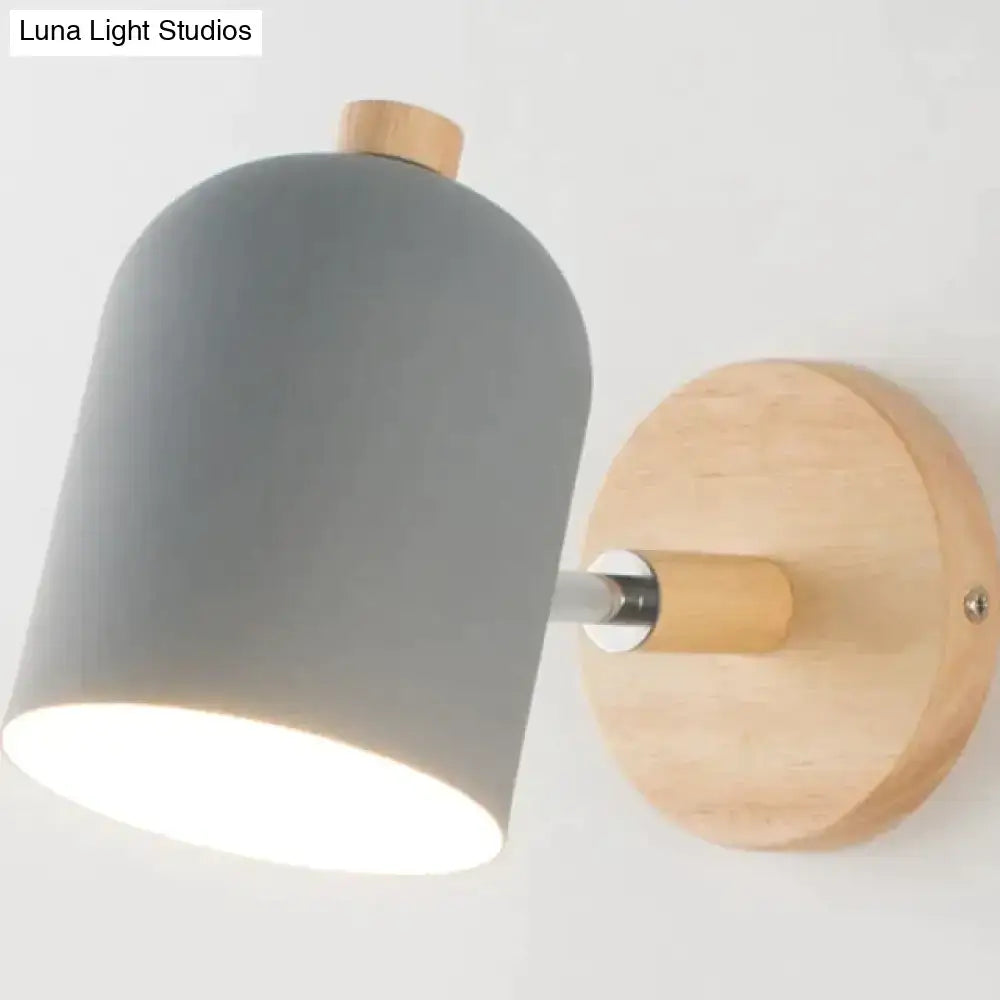 Gray matte wall lamp with wooden base and accents designed as a modern teal and wood bedroom sconce