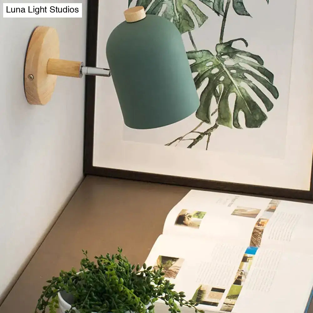 Modern teal wall lamp with matte finish wooden base and knob designed as a bedroom sconce