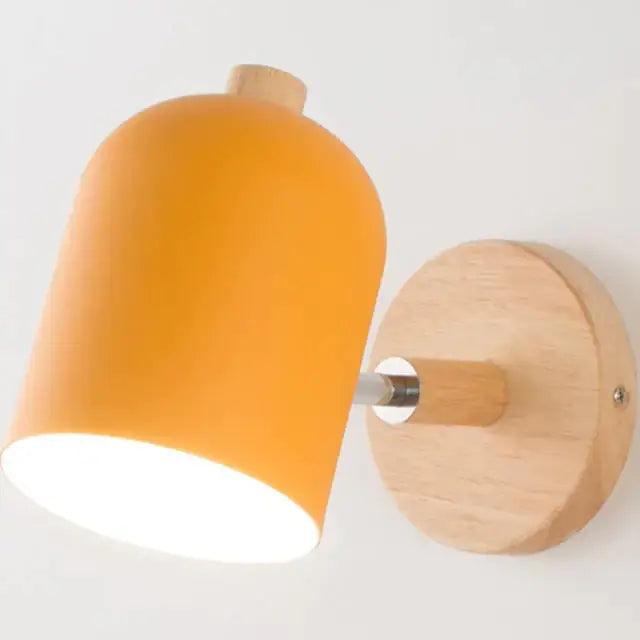 Modern teal and wood wall lamp with orange matte cylindrical shade and natural wood base for bedroom sconce lighting