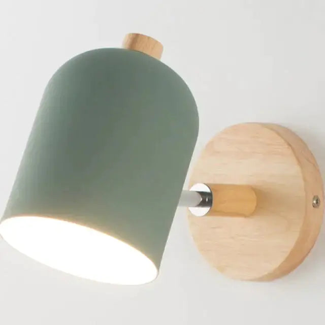 Modern teal and wood wall lamp featuring a sleek matte sage green ceramic shade with natural wood accents for bedroom use