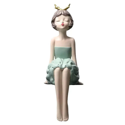 A delicate modern teal bowknot girl figurine resin sculpture seated in a mint green ruffled dress with golden antlers