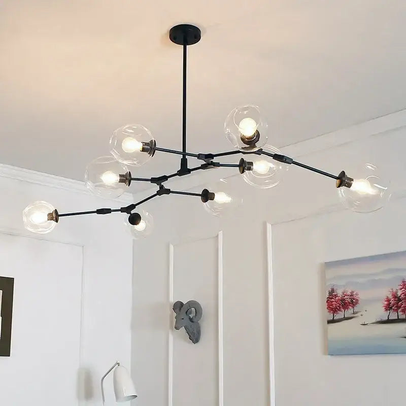 Modern teal glass branch ceiling chandelier featuring a black metal frame with clear glass globe bulbs for dining room decorbites glass branch