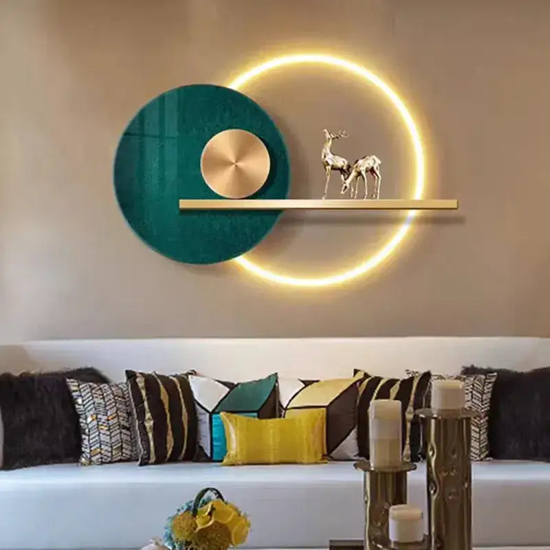 Modern teal and gold led wall sconce featuring a glowing ring and colorful metal deer figurines on a wooden shelf