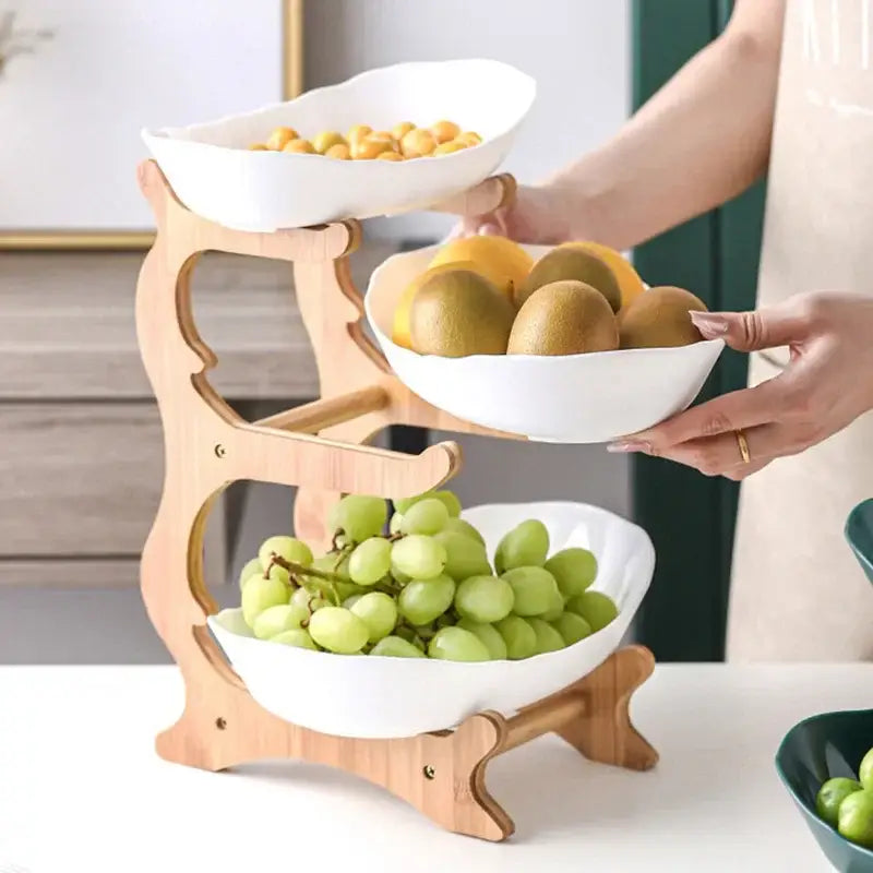 Three-tiered wooden fruit stand with modern teal and white ceramic layer table plates for dining room use