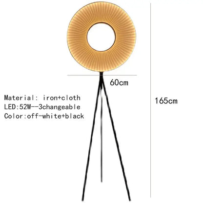 A modern floor lamp with dix heures round fabric pleated off-white shade and black iron legs for dining room lighting