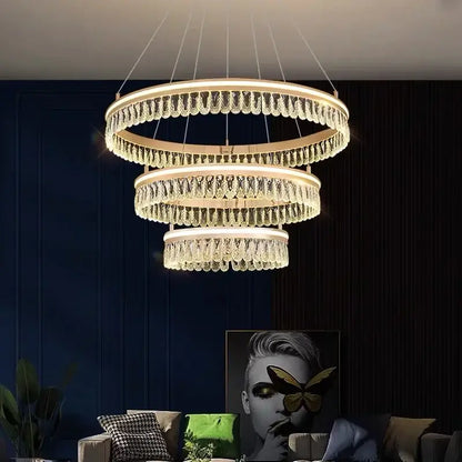 Modern three tier gold crystal led chandelier with cascading droplets and warm glow for dining room decorbites modern crystal