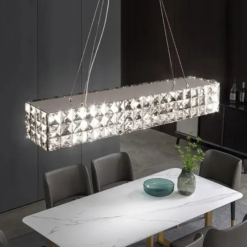 A modern three tiered decorbites crystal led chandelier with sleek geometric faceted panels for living room decor