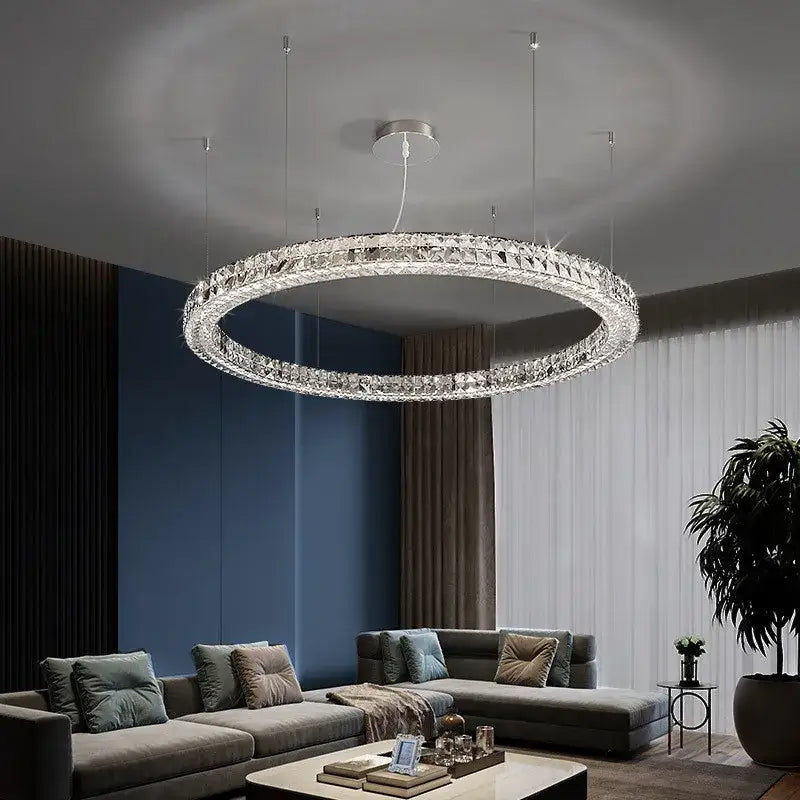 Modern three tiered decorbites crystal led chandelier with a silver metal frame and clear crystal facets in concentric rings