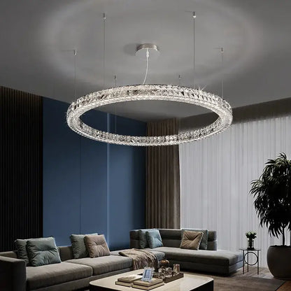 Modern three tiered decorbites crystal led chandelier with a silver metal frame and clear crystal facets in concentric rings