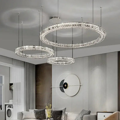 Modern three tiered decorbites crystal led chandelier with circular design hanging in living room ceiling