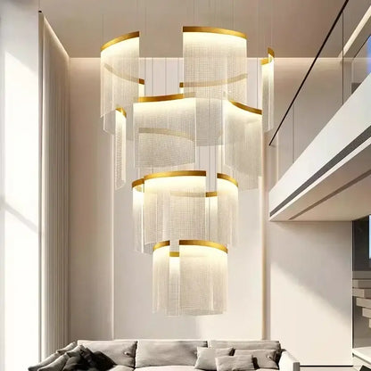 A modern tiered gold led ceiling chandelier with translucent mesh shades for elegant dining room lighting