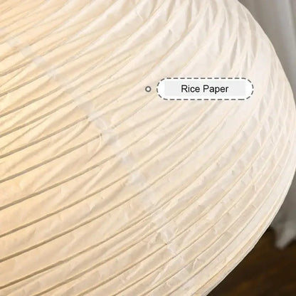 A cream-colored rice paper designer led pendant light with ribbed pleated texture for modern dining room decorbites pendant lights