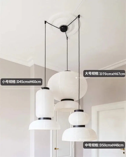 Modern tiered off-white paper pendant lights with black metal accents and spherical shapes for dining room decorbites designer led