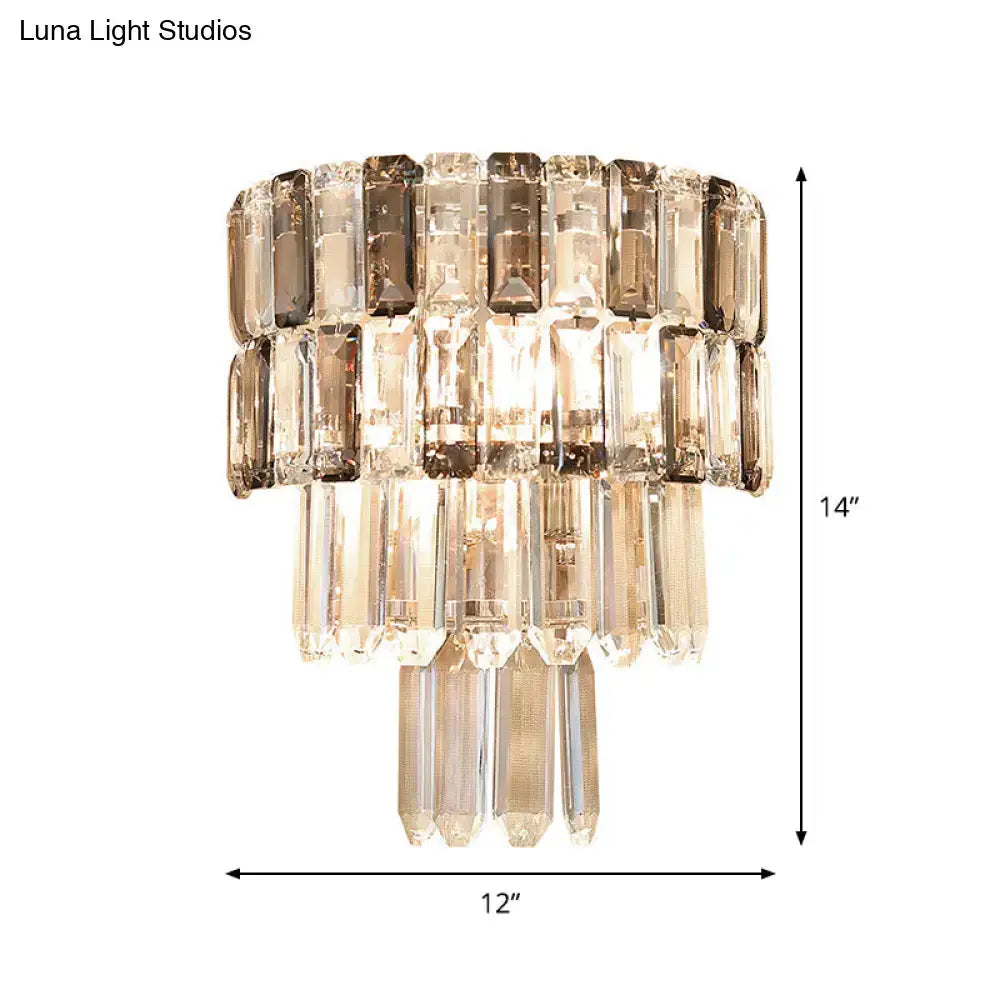 Modern tiered smoke gray crystal wall sconce with cascading smoked and clear crystal prisms for living room decor