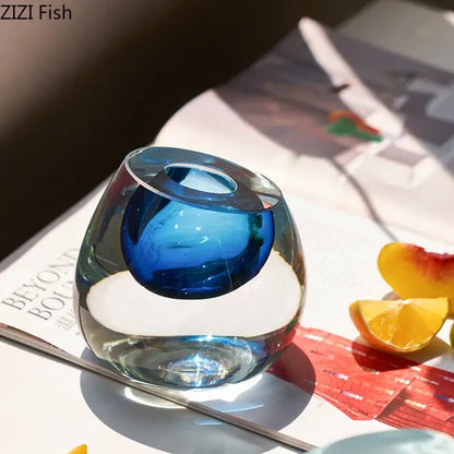 Modern translucent blue colorful glass vase with a smooth rounded design and central indentation as a flower pot decorbites colorful glass decor