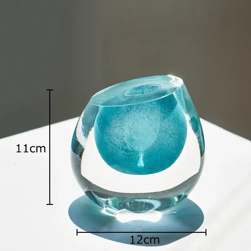 Modern translucent blue colorful glass vase with smooth rounded design and central opening for flower pot decorbites colorful glass