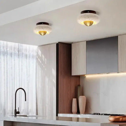 Modern travertine and walnut led ceiling lamp with speckled white glass and gold interior mounted on dark bases