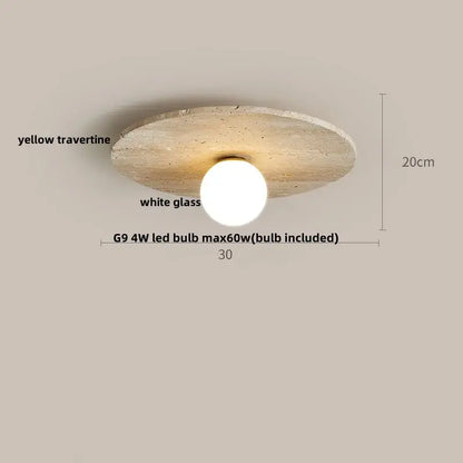 A modern ceiling light with a circular yellow travertine disc and a white decorbites glass ball led globe diffuser