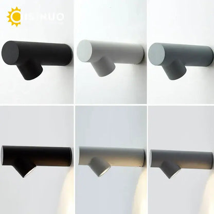 Modern tree branch black and white led wall sconce with a matte black cylindrical body and sleek angular design decorbites led wall