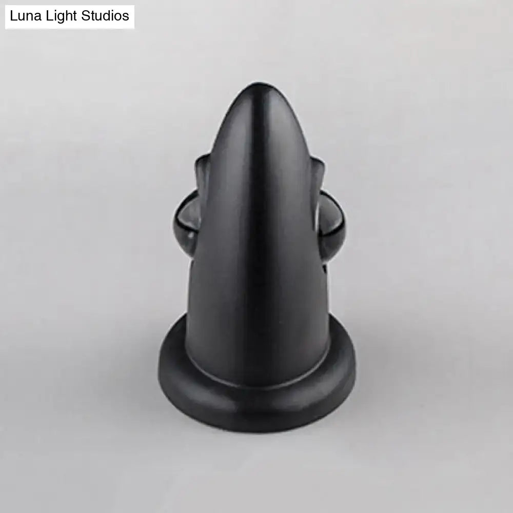 Black matte-finished door stop with sleek tapered design and rounded base for modern led bedroom wall sconce use