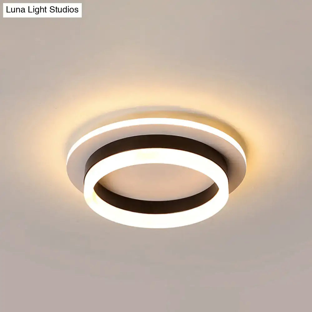 DecorBites™ compact metal LED flush mount ceiling light with acrylic diffuser featuring modern circular rings emitting warm glow