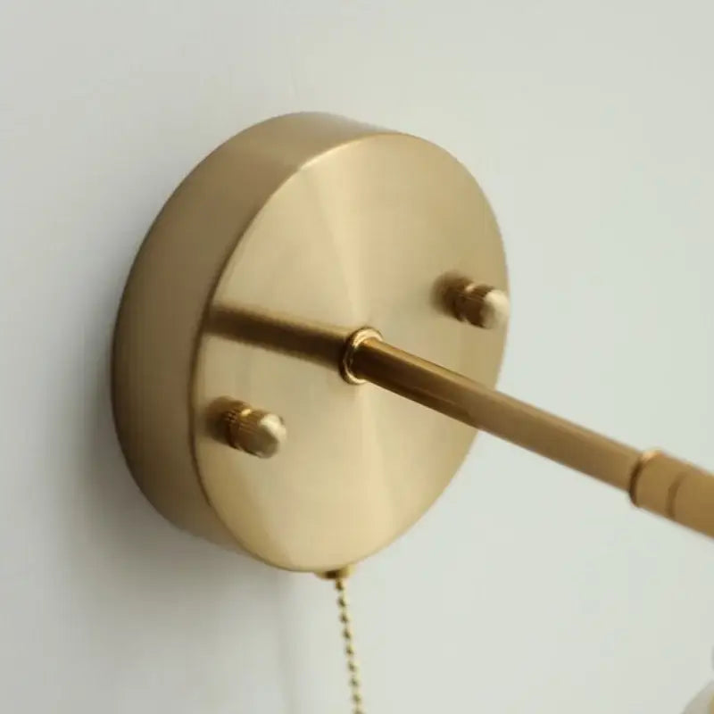 Modern turquoise blue glass wall sconce with brass-finished circular base and extending arm by decorbites blue glass