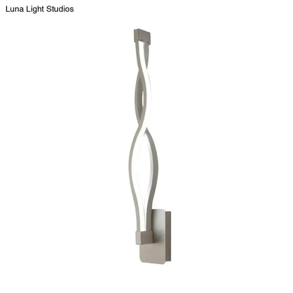 Modern silver-toned led wall sconce with a sleek twisted design and minimalist rectangular mounting plate for bedroom light