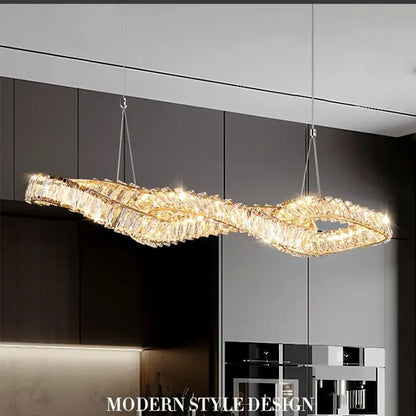 A modern twisted gold metal crystal pendant light with clear crystals and warm lighting for dining room decorbites gold metal