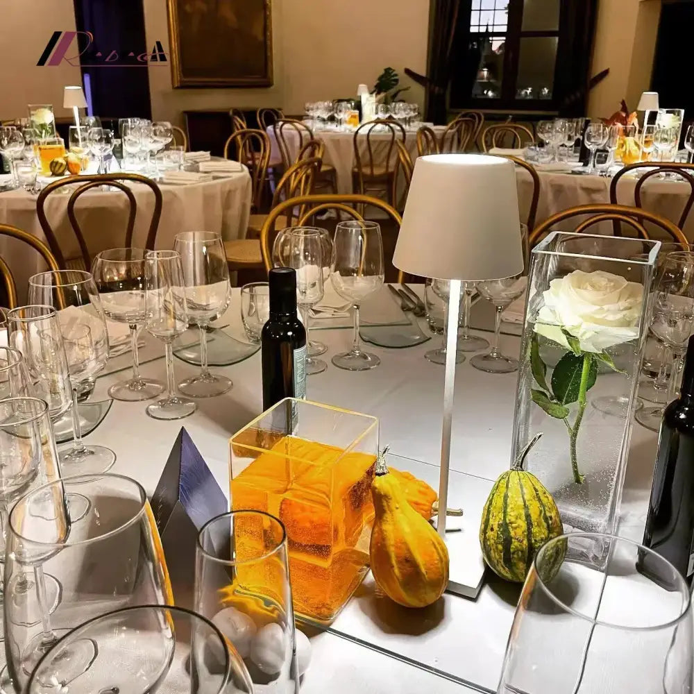 Modern usb rechargeable acrylic table lamp shaped as a clear cube with amber liquid and orange slice garnish