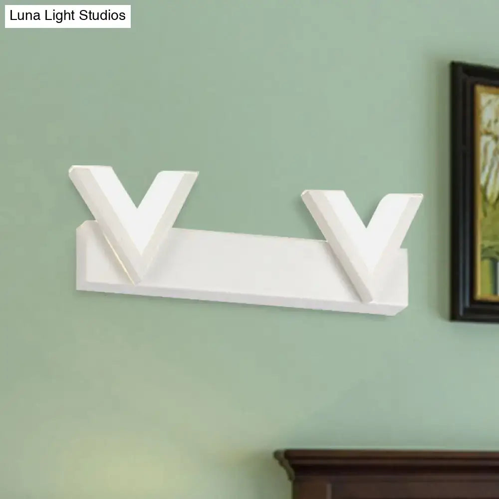 Modern white v-shaped wall-mounted coat rack with sleek design complementing warm white led vanity light decor