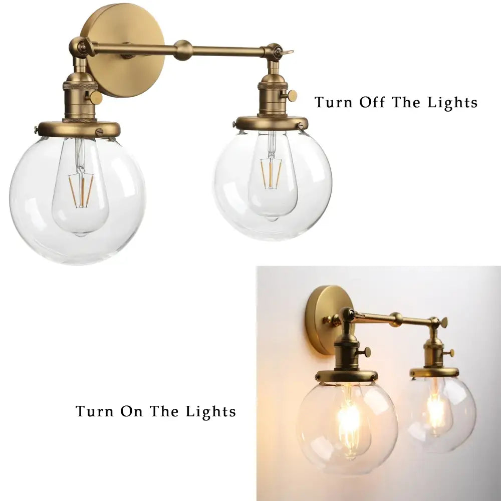 Modern vintage brass wall sconce with double ball heads clear glass globe shades and exposed filament bulbs for bedroom light