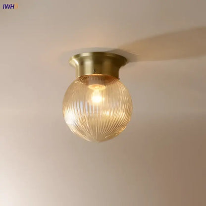 Modern vintage gold glass ball ceiling light with brass finish and textured amber-tinted glass shade for bedroom decorbites glass ball