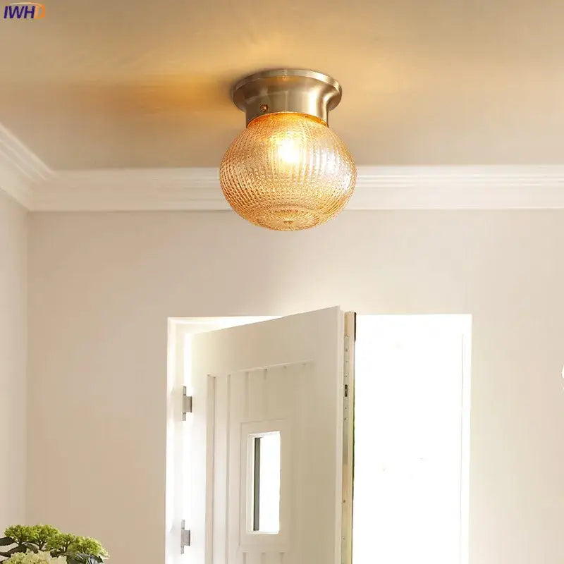 Modern vintage gold glass ball ceiling light with warm-toned textured glass and brushed brass fixture for bedroom decorbites glass ball