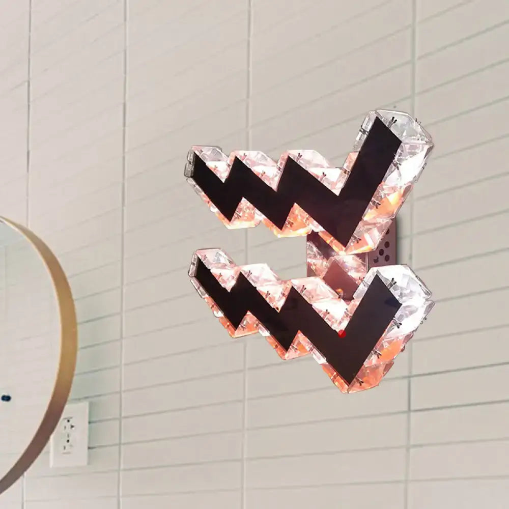 Modern w-shaped beveled crystal wall lamp with faceted crystal design and black zigzag accents for bedroom use