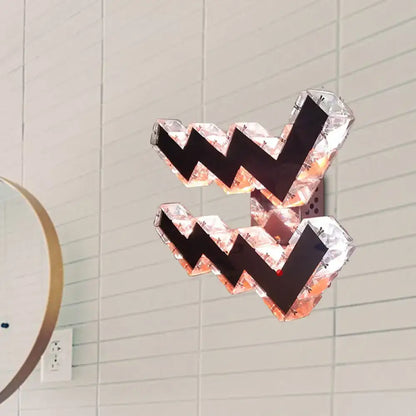 Modern w-shaped beveled crystal wall lamp with faceted crystal design and black zigzag accents for bedroom use