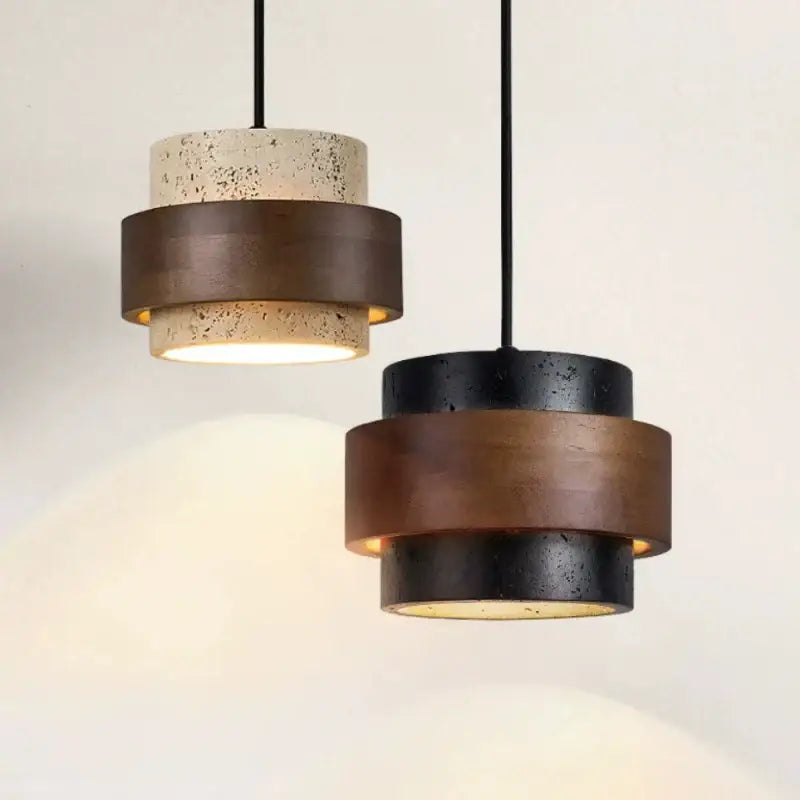 Modern wabi sabi tiered stone pendant light with textured concrete and matte bronze finish for dining room use