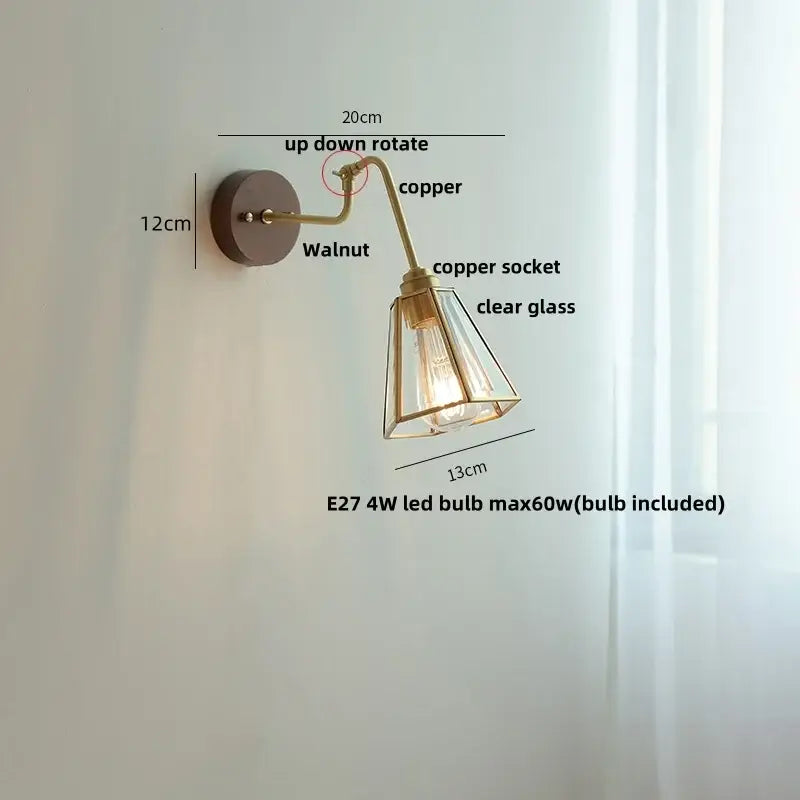 Modern walnut and brass clear glass led wall sconce with copper finish, rotating arm, and clear glass decorbites shade
