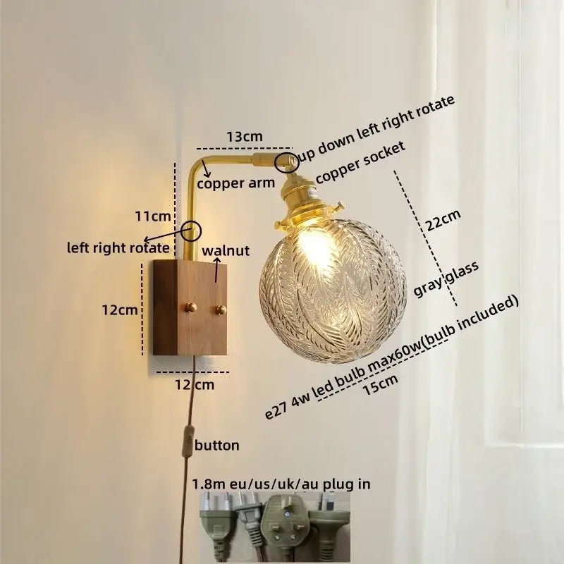 Modern walnut copper wall sconce with clear glass globe and intricate leaf etching for stair lighting