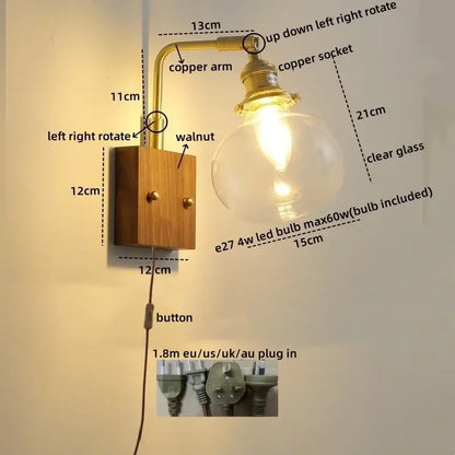 Modern wall sconce with clear glass bulb, walnut wood base, and walnut copper brass arm for stair lighting