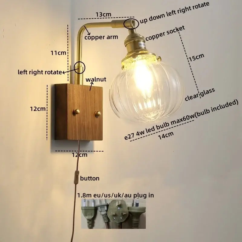 Modern walnut copper wall sconce with a brass arm and clear ribbed glass bulb for stair lighting